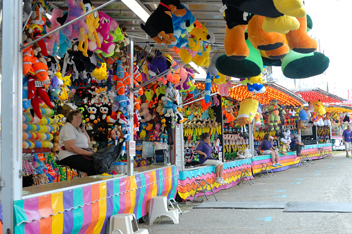 Hickory, NC, USA - September 4, 2015: Game vendors do their business on the midway of a county fair.
