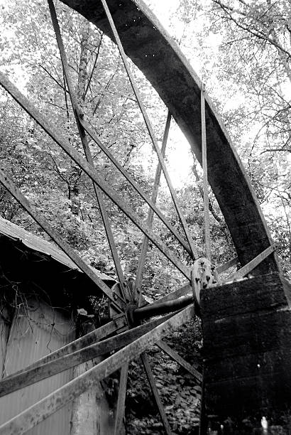 istock Old water wheel sits rused and not operating 491309618