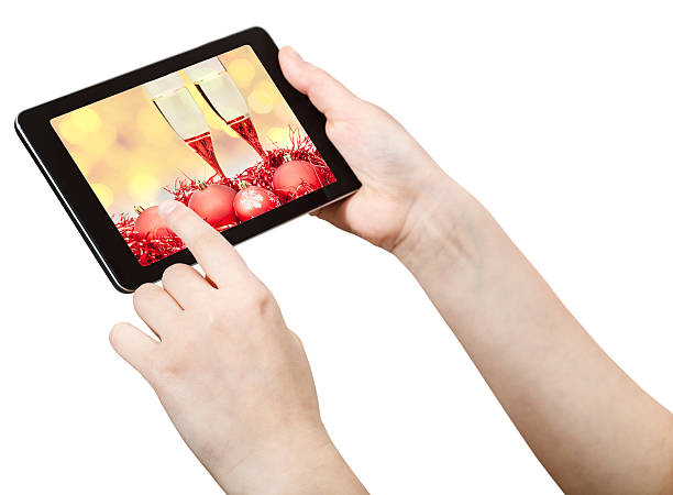 istock hand clicks on tablet pc with Xmas still life 491311036