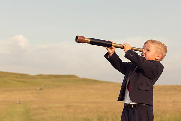 istock Young Boy Businessman Looking throught Telescope 491311428
