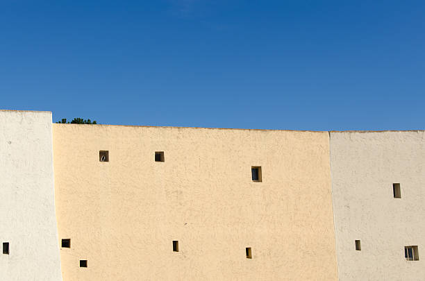 Fontage of a beige building with blue sky