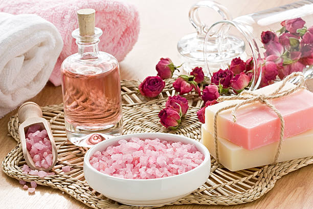 SPA set SPA treatment set with sea salt, rose aroma oil and soap bar botanical spa treatment stock pictures, royalty-free photos & images