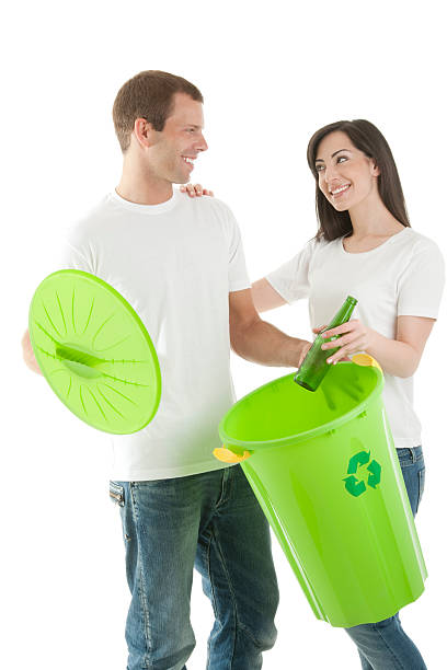 istock Young Couple Recycling Glass Bottles 491322583