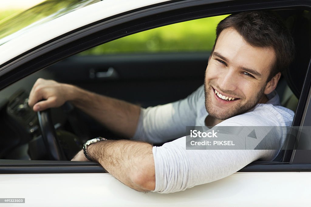 Young man sitting in a car Adult Stock Photo