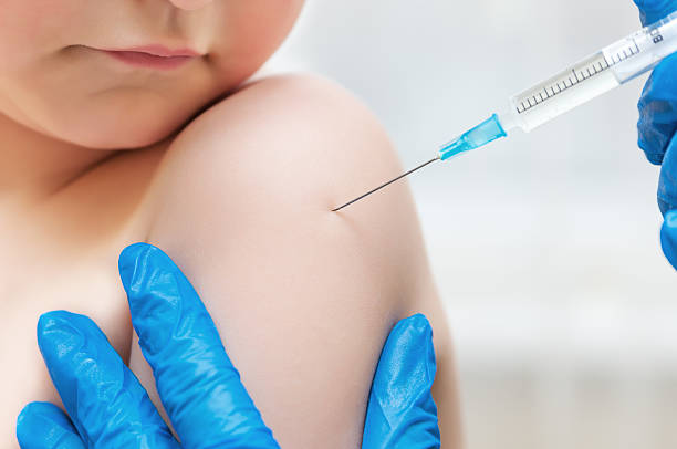 Boy and vaccine syringe Boy and vaccine syringe tracheotomy tubing stock pictures, royalty-free photos & images