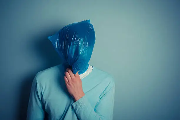 Photo of Man with a plastic bag over his head