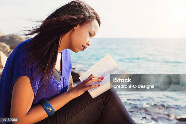 Young Girl Studying Her Bible By The Sea Stock Photo - Download Image Now - Bible, Women, One Woman Only