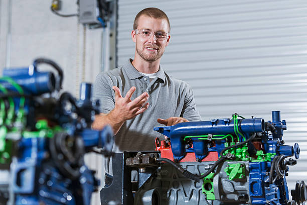 istock Man in auto mechanic school with diesel engine 491331796