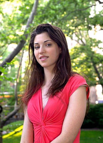 istock lady in red in park 491333628