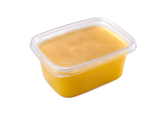 plastic container with ghee butter isolated plastic container with ghee butter isolated on white background clarified butter stock pictures, royalty-free photos & images