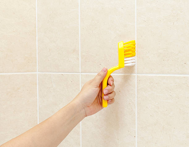 istock woman using brush to wash tiles 491337066