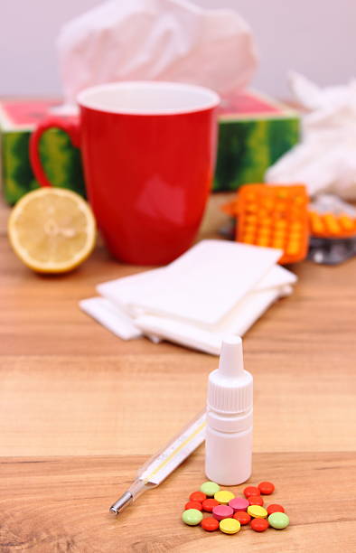 istock Pills and nose drops for colds, used handkerchiefs and tea 491346564