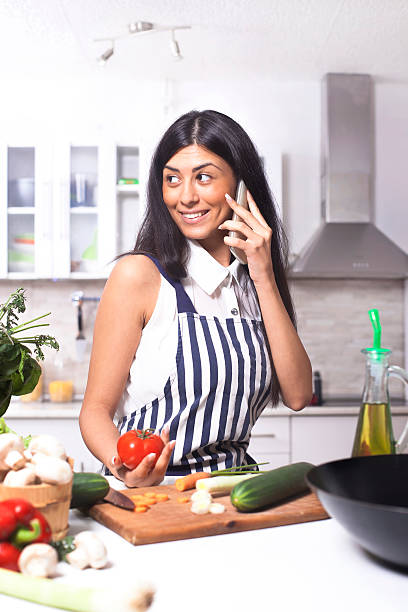 istock Young  woman in kitchen and talking 491346672