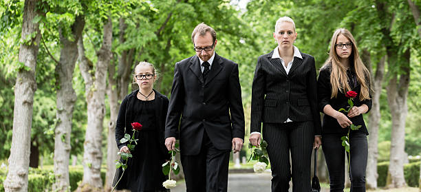 istock Family walking down alley at graveyard 491352514