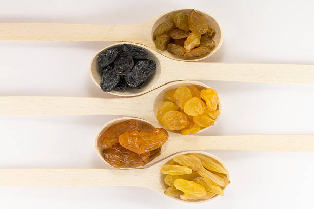 istock Colorful raisins in a wooden spoon 491359168