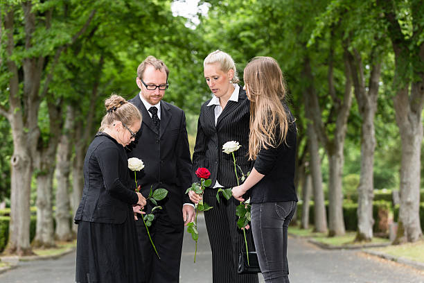 istock Family mourning on funeral at cemetery 491362188