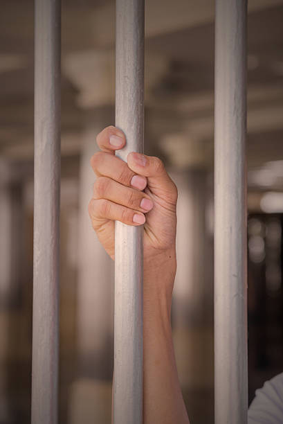 istock Hands of a man try to get out from jail 491362326