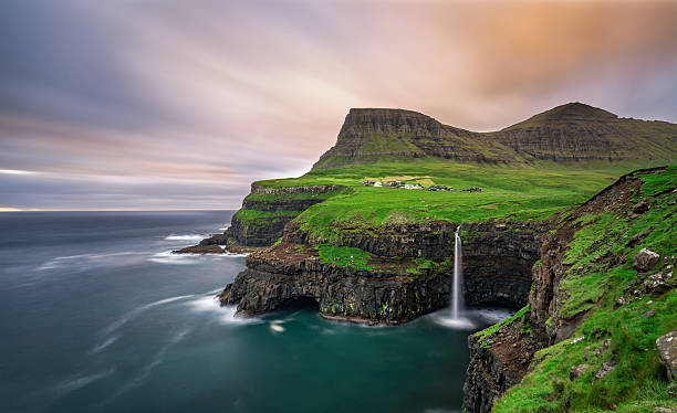 Gasadalur village and its waterfall, Faroe Islands, Denmark stock photo
