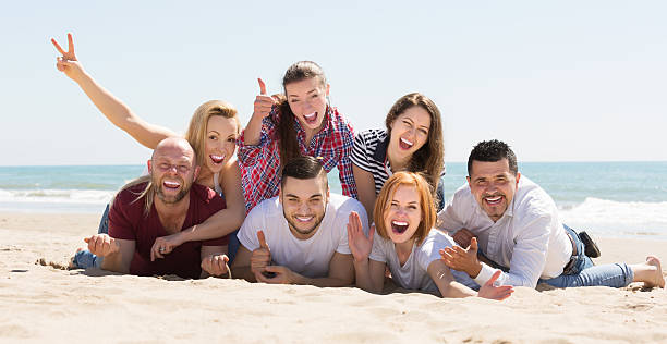 istock Adults relaxing at sandy beach 491362832