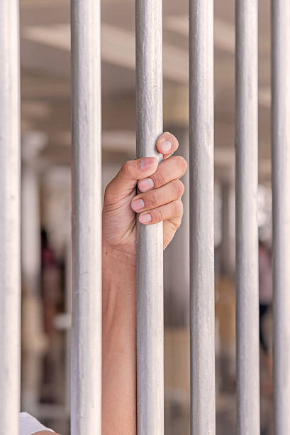istock Hands of a man try to get out from jail 491363714