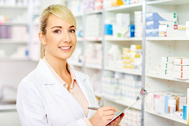 istock Confident chemist holding clipboard at pharmacy 491365002