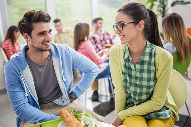istock Happy couple communicating on lunch break in cafeteria. 491365304