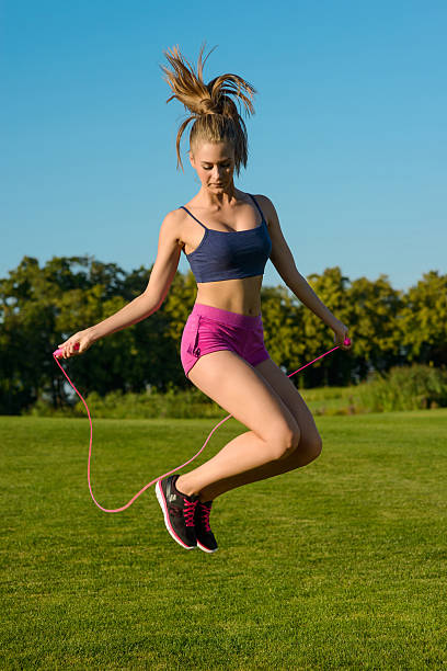 istock Girl fun jumping on jump rope with a smile. 491366182
