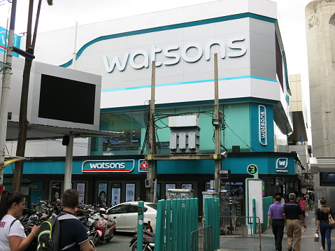 Bangkok, Thailand – September 1, 2015: View of Watsons shop from the sidewalk of Siam shopping area in Bangkok. Watson is retail shop selling health and beauty goods. There are people walking past the shop. 
