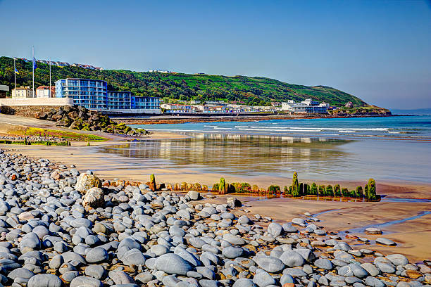 Westward Ho Devon England near Bideford in colourful HDR Westward Ho Devon England near Bideford in colourful HDR with pebbles on the beach and blue sea and sky Devon stock pictures, royalty-free photos & images