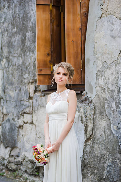 istock Smiling bride holding big wedding bouquet 491375150