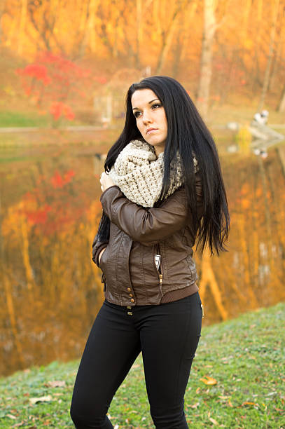 istock Young pretty woman in autumn park 491375567