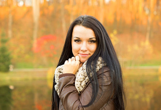 istock Young pretty woman in autumn park 491375571