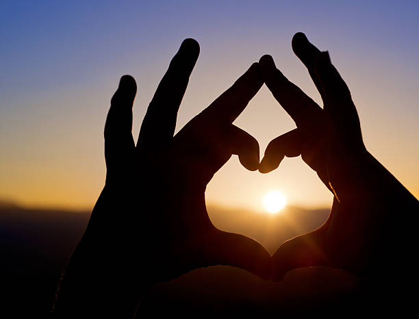 istock heart shape made of two palms 491376121