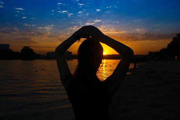 istock silhouette a girl on the sunset 491377272