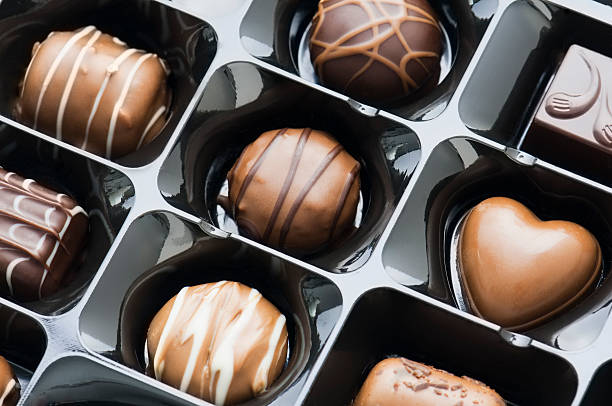 istock Gift box of white dark and milk chocolate candy 491378219