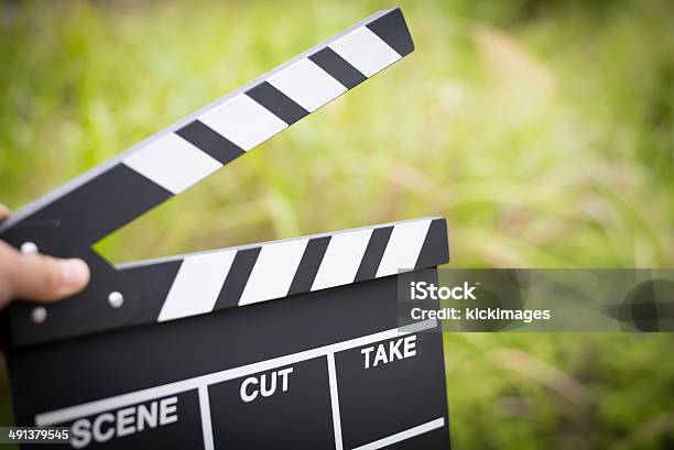 Hand Holding Clapperboard Stock Photo - Download Image Now - Movie, Non-Western Script, Film Slate