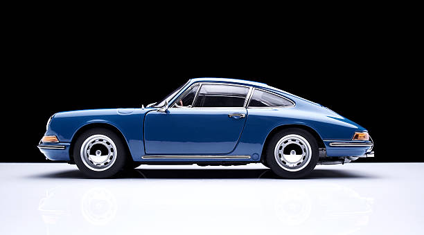 Beaconsfield, UK - October 5, 2015: A 1:18 scale model of a 1964 Porsche 911 made by Auto Art, set against a solid black background.