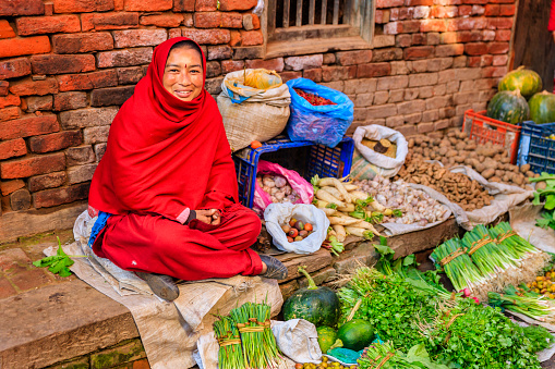 Nepali street  seller selling vegetables on the streets of Kathmandu, Nepal. Bhaktapur is an ancient town in the Kathmandu Valley and is listed as a World Heritage Site by UNESCO for its rich culture, temples, and wood, metal and stone artwork.http://bem.2be.pl/IS/nepal_380.jpg