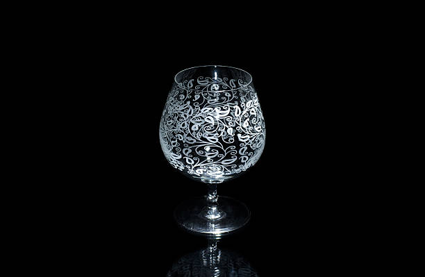 istock Empty cognac glass, isolated on a black background. 491381326