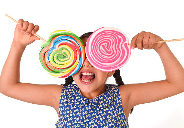 istock happy female child holding two big lollipop having fun playing 491389248