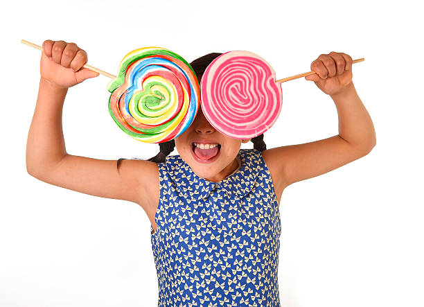 istock happy female child holding two big lollipop having fun playing 491389302