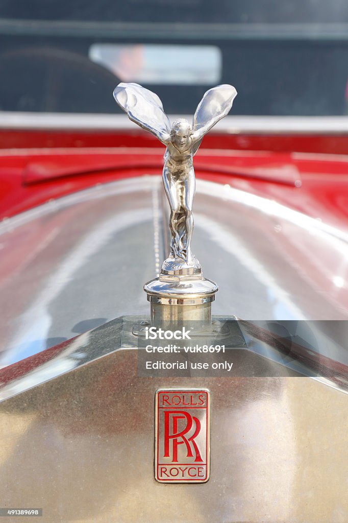 Emily Opatija, Сroatia - June 25, 2013: The front end of the beautiful old Rolls Royce with the hood ornament, Spirit of Ecstasy, parked on waterfront of Opatija. The ornament is in the form of a woman leaning forwards with her arms outstretched behind and above her. Billowing cloth runs from her arms to her back, resembling wings. 1910-1919 Stock Photo