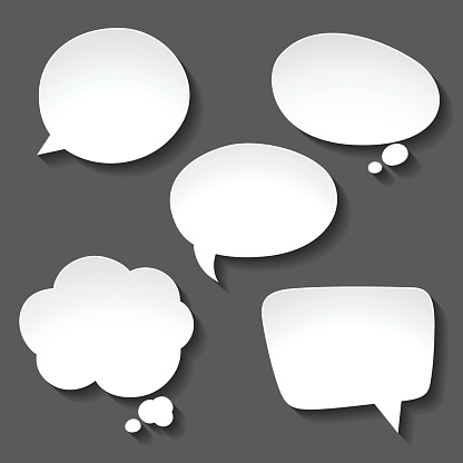 Abstract white paper speech bubbles on gray background.