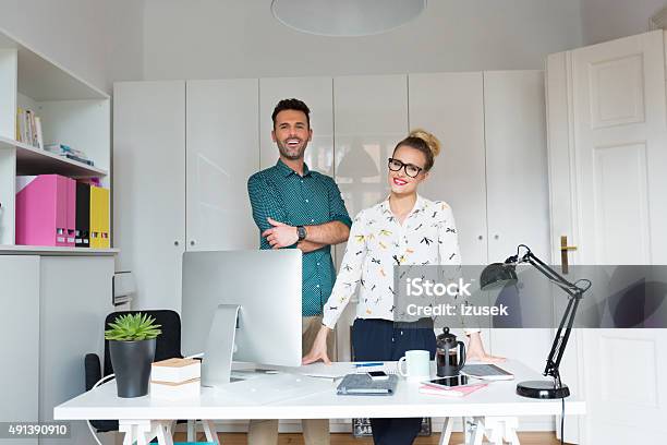 Woman And Man In An Office Stock Photo - Download Image Now - 2015, Adult, Adults Only