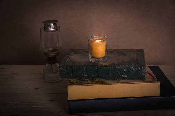 istock Set with ancient books with candle lights and lantern 491392762