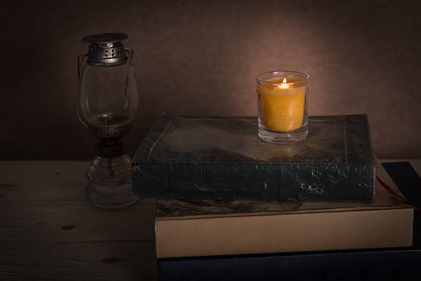 istock Set with ancient books with candle lights and lantern 491392792