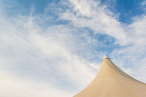 image of circus tent and clear blue sky in background.