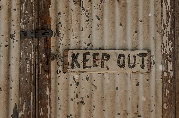 istock Keep out handwritten sign on closed rustic weathered door 491406432