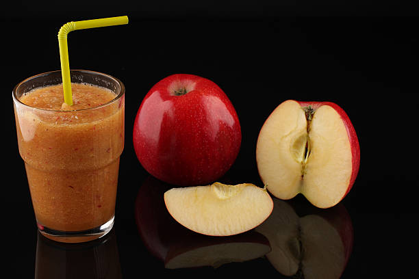 istock apple smoothie in glass and apples on black acrylic sheet 491407964