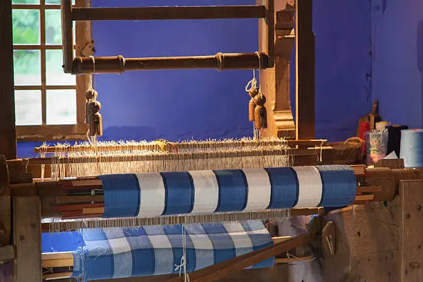 blue and white colored weave on a loom